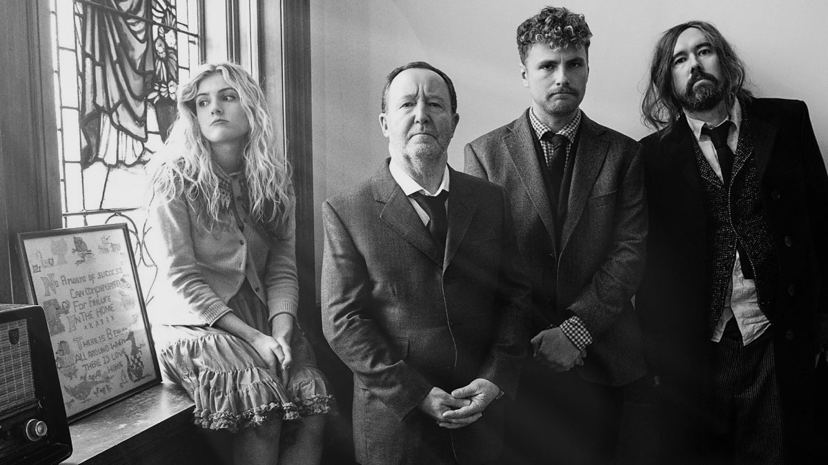 The cast of A Better Place beside a stained-glass window