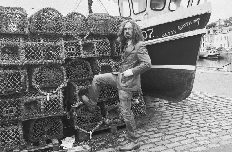 The Witches of the East Neuk: Rupert D'Ssane leaning on lobster pots
